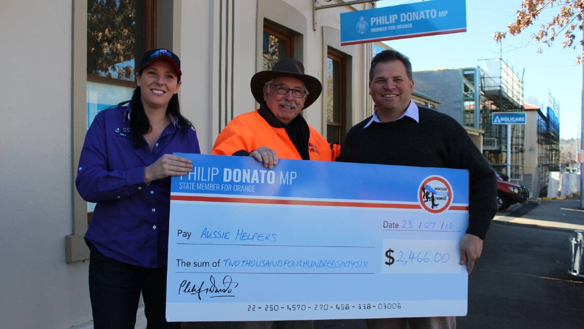 Krystal Haycock and Brian Egan from Aussie Helpers charity with Member for Orange, Philip Donato with the cheque going towards drought effected farmers.