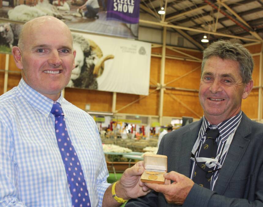 NSW Stud Merino Breeders Association new president, Angus Beveridge, presented with the badge of office by outgoing president, James Derrick.