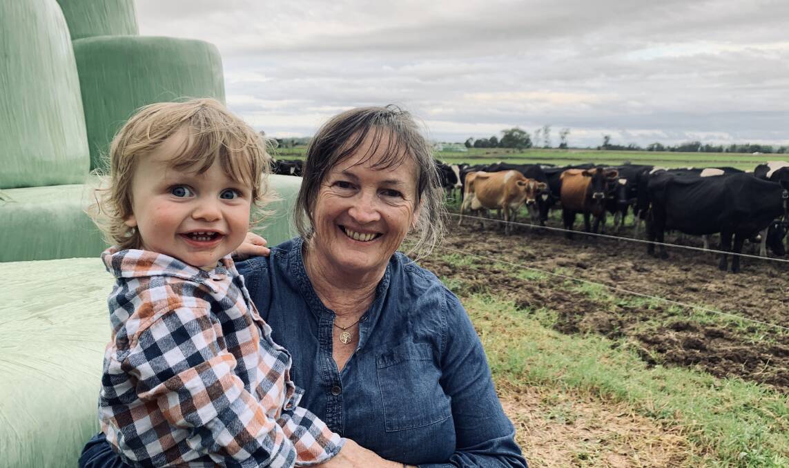 Megan Nicholson with her 15-month-old grandson Albert at their Taree dairy in the Manning Valley. Photo: Rachel Nicholson