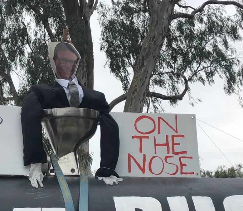 An effigy of Water Resources Minister David Littleproud was thrown into the Murray River. Photo by Olivia Calver.