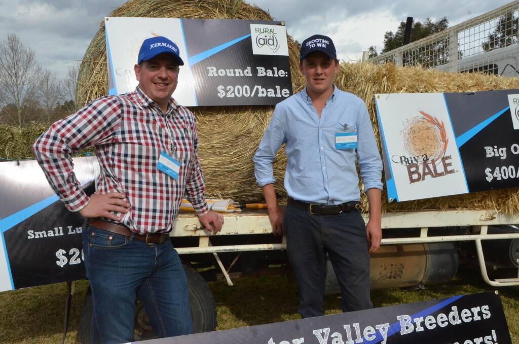 Tim Johnson from Scone and Harrison Badger from Kitchwin Hills  taking donations at the “Buy A Bale” truck at a Godolphin parade. Photos by Virginia Harvey. 
