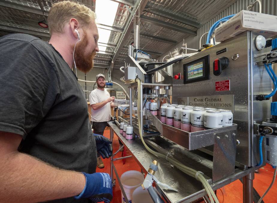 The Welder's Dog brewers Daniel 'Bean's Coffey and Phil Stevens on the canning line. Photos by The Welder's Dog.
