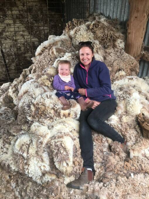 It's shearing time at the Johnstons. Tessa Nicholson with her one-year-old daughter Sophie at their West Wyalong property.