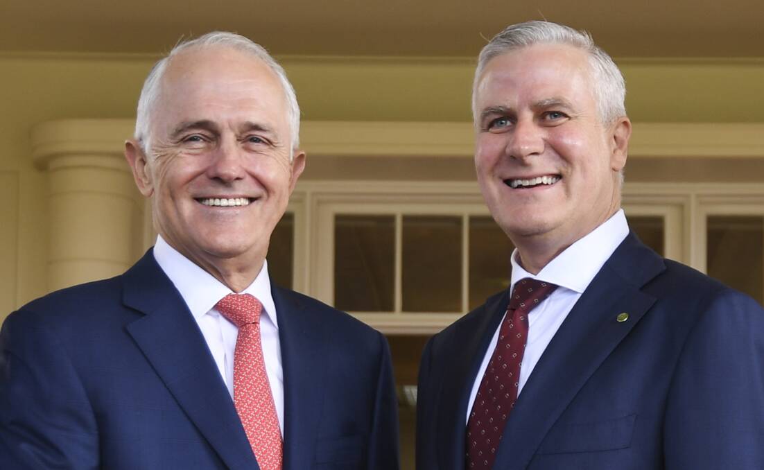 Nationals party leader Michael McCormack (right) is congratulated by Australian Prime Minister Malcolm Turnbull after being sworn-in as Australia's Deputy PM.