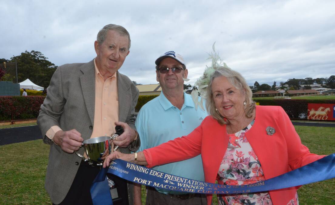 Port Macquarie locals and part-owners David and Helen Parker, flank trainer Neil Godbolt after Je Suis Tycoon's win at Port Macquarie.    