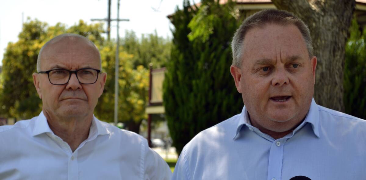 Gippsland East MLA Tim Bull, pictured with Bushfire Recovery Victoria chairman Ken Lay, has called for vegetation clearance changes to protect newly-constructed exclusion fences from being damaged by falling trees.
