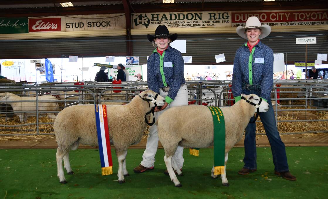 Baradine Central School students Emily Hoffman and Molly Murray with the champion and reserve champion. Photo: Billy Jupp 