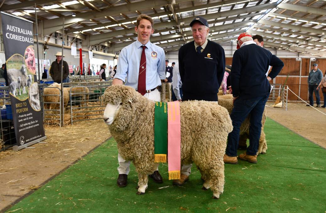 Handler Lachlan Evans, Trinity College Goulburn and Roseville Corriedale stud principal Tony Manchester, Kingsvale, with the best sire fleece winner. Photo: Billy Jupp 