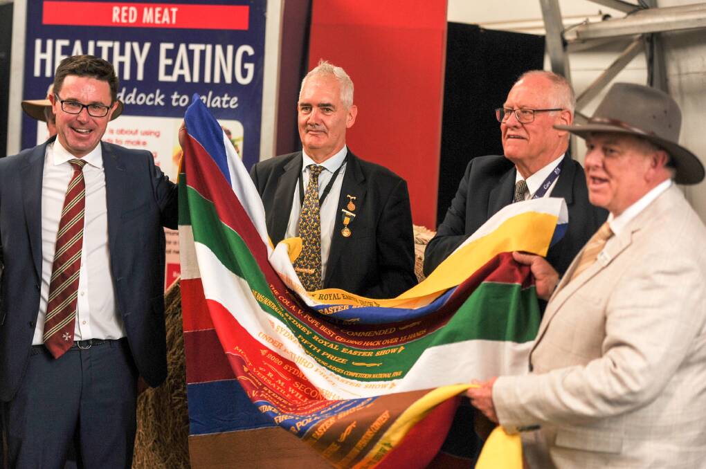Federal Agriculture Minister David Littleproud accepts a Sydney Royal Easter Show ribbion rug from members of the RAS NSW. Photo: Lucy Kinbacher 