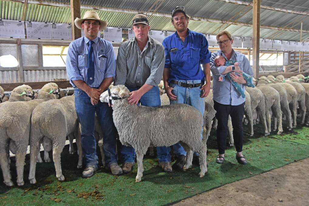 Auctioneer Luke Heagney of Armitage and Buckley Livestock, Armidale, vendor Justin Tombs of Harewood Dohnes stud, Woodlands, Armidale, buyers Nick and Kate Saunders, Inverinate, Wollomombi with the top-selling ram. Photo: Billy Jupp 