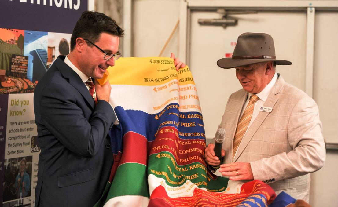 Federal Agriculture Minister David Littleproud accepts a Sydney Royal Easter Show ribbion rug from RAS NSW general manager Murray Wilton. Photo: Lucy Kinbacher 