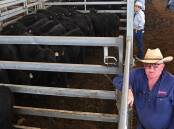 Inverell stock agent Ben Lehman, Lehman Stock and Property, with Angus steers sold by Paul and Laura Cush, Myall Park, Warialda, for $2418.