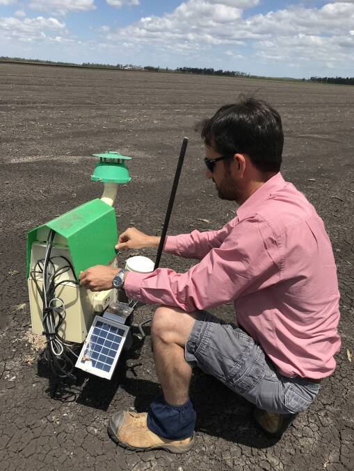 Elders Toowoomba agronomist Matt Kenny checks one of the trapview units being used to monitor for early flights of Fall armyworm. Photo: Supplied 