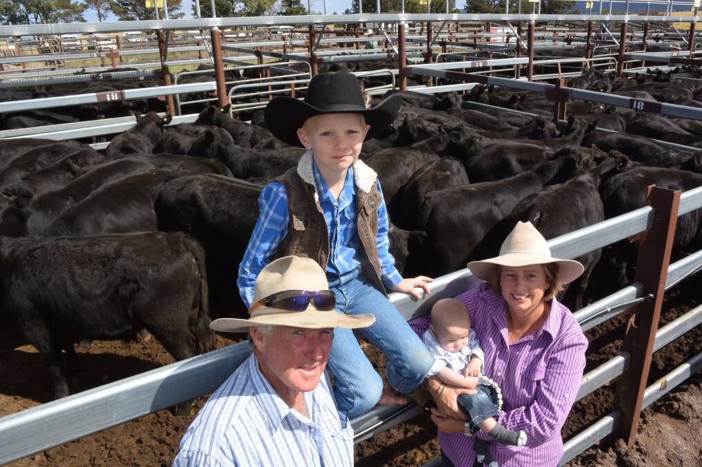 VOLUME VENDORS: Neville and Sue Grogan pictured with their grandchildren Jackson and Lachlan at a previous Tenterfield weaner sale. 