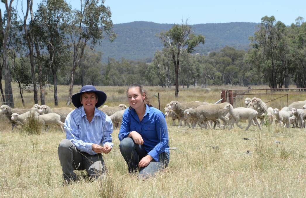 Rachel and Kate Rummery with Merino ewes and lambs at "Yarragool", Bendemeer. Photo by Rachael Webb