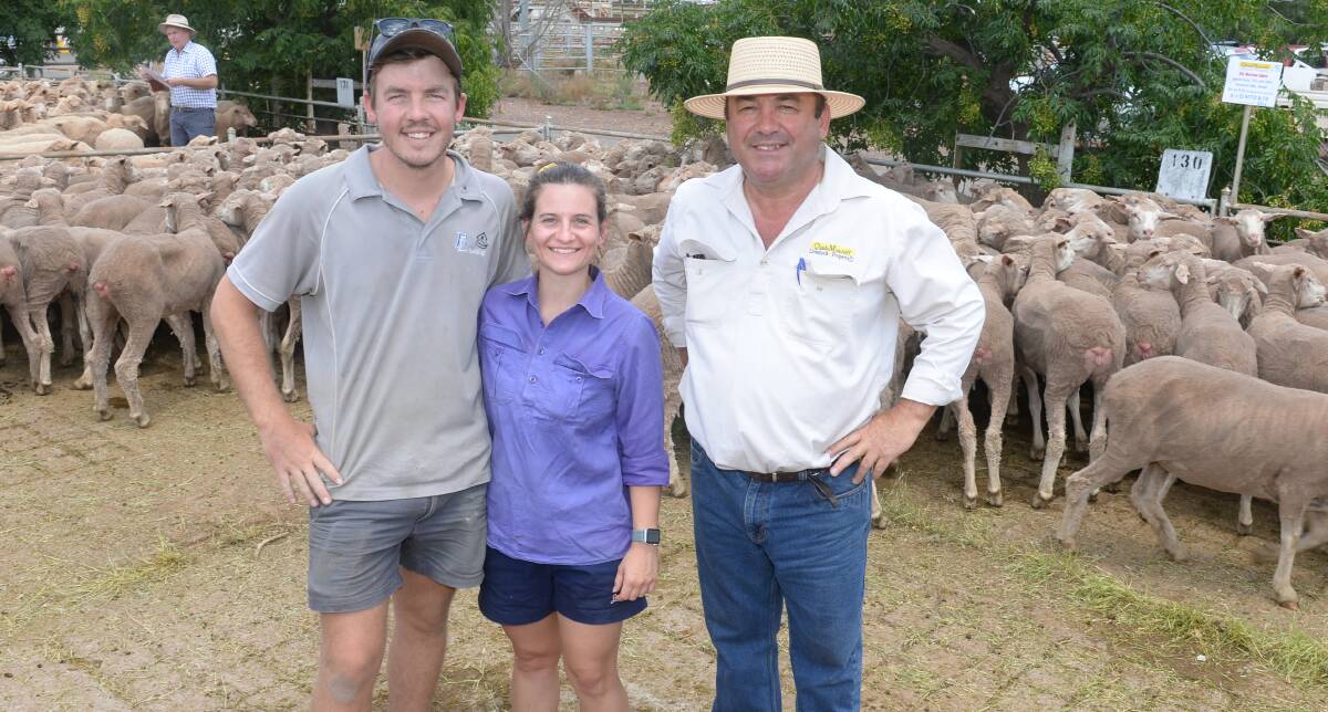 Brad and Kelsea Lamb, Birdwood, West Wyalong, with agent Paul Quade, Quade Moncrieff Livestock and Property with the $364 top-priced Merino ewes bought from Darryl Kitto and familys Cairn Mount, Tallimba. The pen of 195 head are the first the couple have bought for their own business.