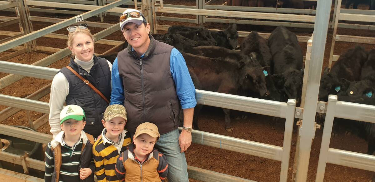 Kate and Nathan Eather, Bellata, with sons Lachie, Max and Charlie and their homebred Angus weaner steers which fetched up to $700 a head.