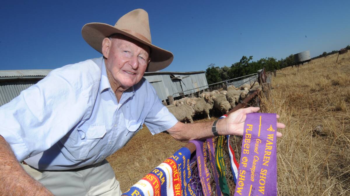The late Ian Wass showing some of the many championship ribbons won by his Woodside Merino stud sheep.