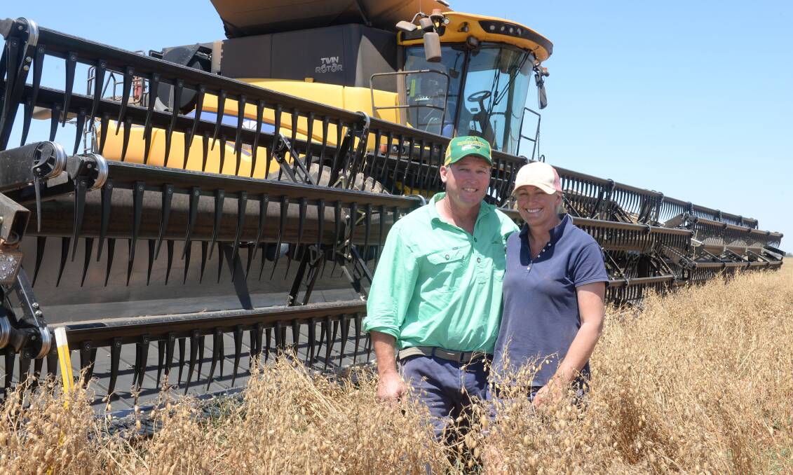 Stuart and Sue Barclay with their labour-saving 60-foot front on a New Holland header at Kilbirnie, Nyngan.