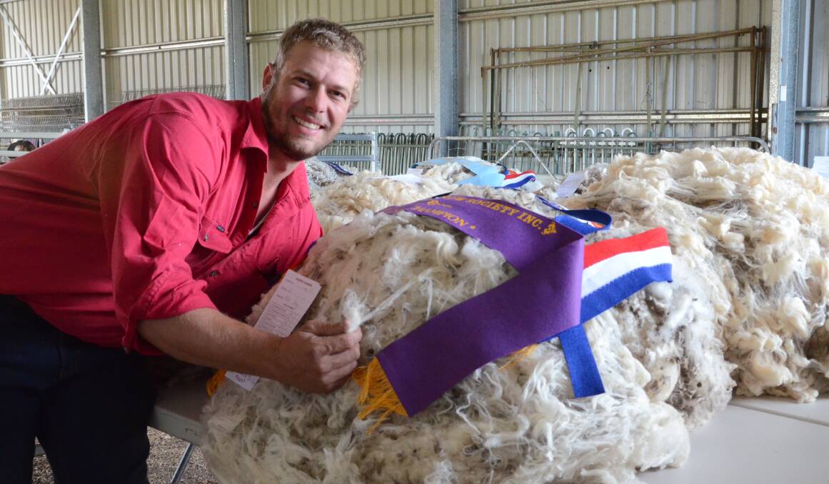 Clive Brown, Mt Fay, Wuuluman, was most successful exhibitor in the Merino fleece section and pictured with his grand champion fleece of 20.3 micron weighing 6.5 kilograms and valued at $94.31. Mr Brown also took out reserve grand champion fleece and best commercial fleece of 19.2 micron weighing 7.5kg valued at $105.18.