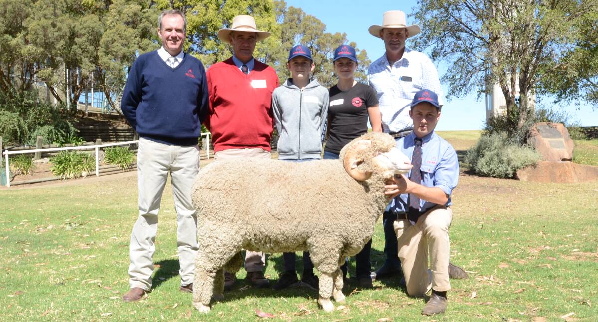 The $18,000 top-priced ram with auctioneer Paul Dooley, Tamworth; Egelabra general manager, Cam Munro; buyers Nicholas, Amy and Dave Motley, manager, Gerar Station, Nyngan, with Austin Grace holding the ram.