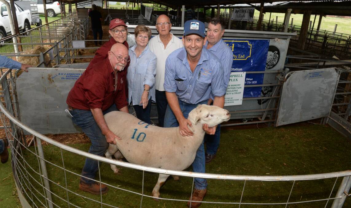 The $3700 record-priced ram with breeders Julie Huie and Jeff Lucas, Westmoreland stud, Wisemans Creek,, buyers Gloria and Des Houlihan, Mandagery View stud, Manildra, and Andy Carter, McDonald Lawson, Mudgee, with a firm hold.
