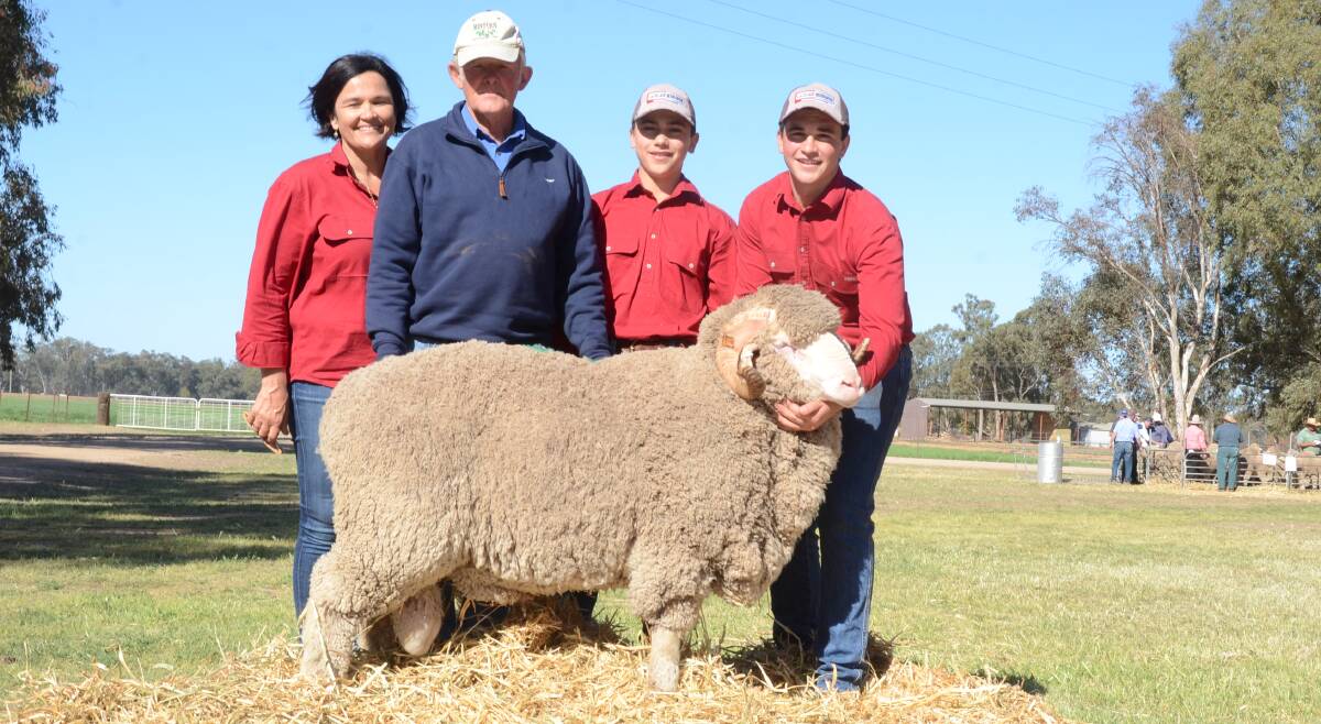 Margot Rubie, Lachlan Merinos, with buyer of the $7000 top-priced Merino Sid Dickins, Audreylea, Booligal, Campbell Rubie and Mitchell Rubie holds the ram.