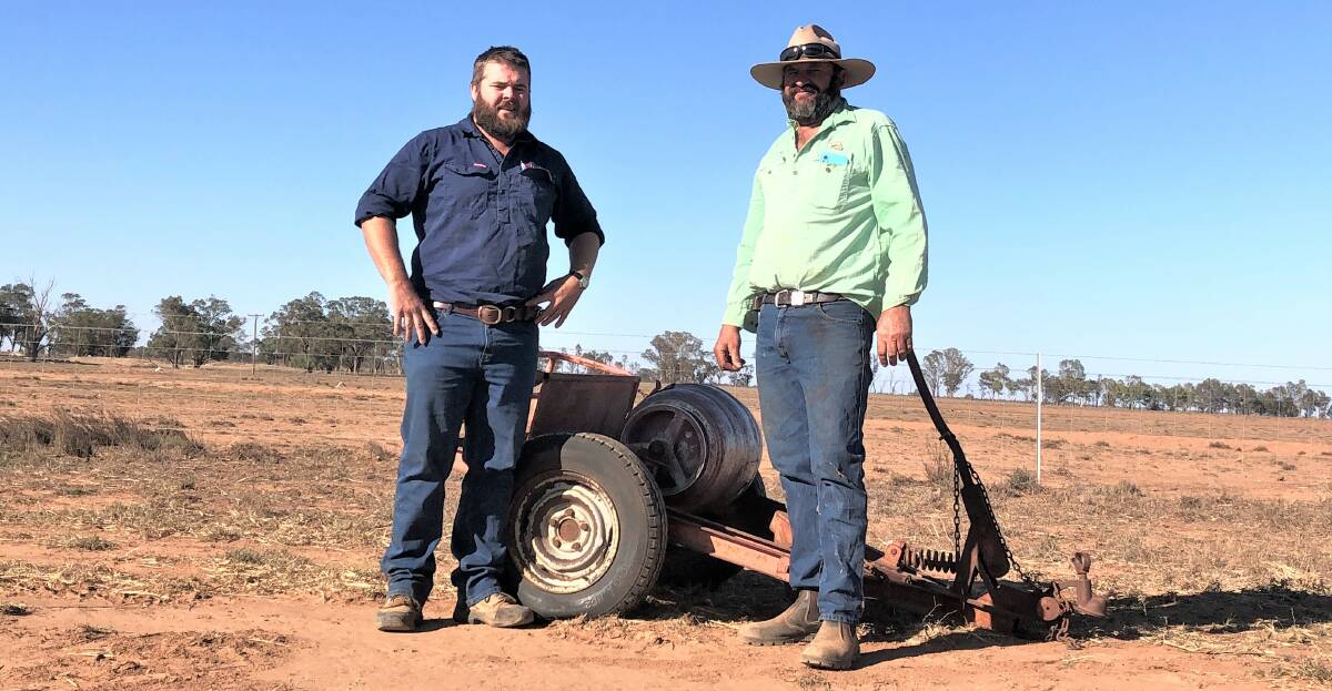 Trangie farmer and Border Leicester stud breeder, Peter Howe, with Central West Local Lands Services biosecurity officer, John Ellis, and his rabbit bait layer in use at Dunield.