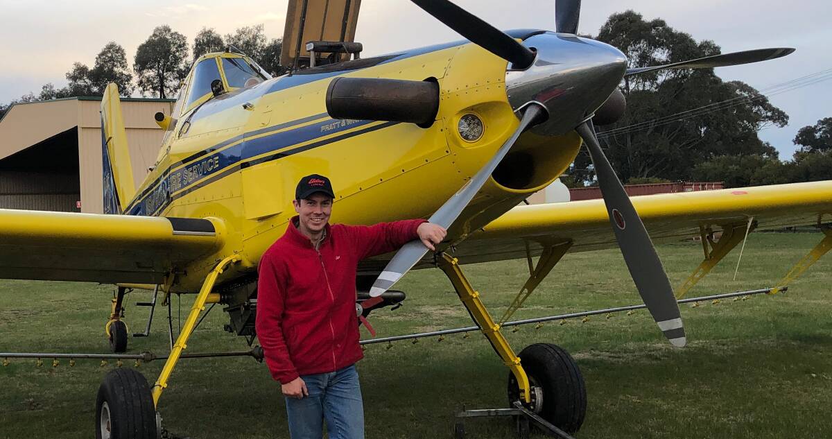 Elders Cowra agronomist Mitch Dwyer with one of six aircraft run by Fred Fahey Aerial Services, Cowra, working flat out over crops this wet winter.