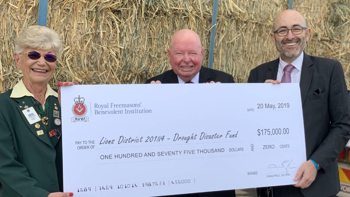 Lions district drought disaster fund hay distribution coordinator Anne Jones, Geurie Club, accepts the $175,000 cheque presented by Royal Freemasons' Benevolent Institution's Douglas James and CEO Frank Price. Photo: Supplied