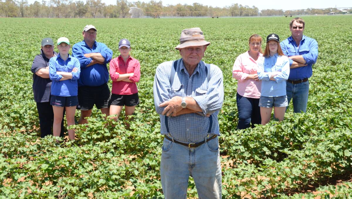 Malcolm Corderoy with (left) Mandy, Chloe, Ian and Emma and at right, Pedr, Jenny and Ian in irrigated cotton at Cowal Park, Narromine. The cowal is behind the tree line where the inland rail line is proposed to dissect the property.