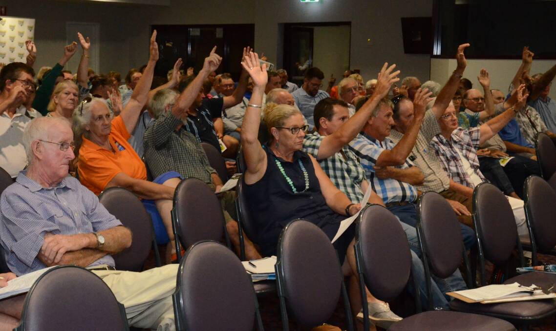 A vast majority of attendees raise their hands in support of the NSW Farmers, pledging not to sign land access agreements at the Narromine meeting. The same estimated 75 per cent of people also supported the organisation at an earlier meeting in Coonamble.