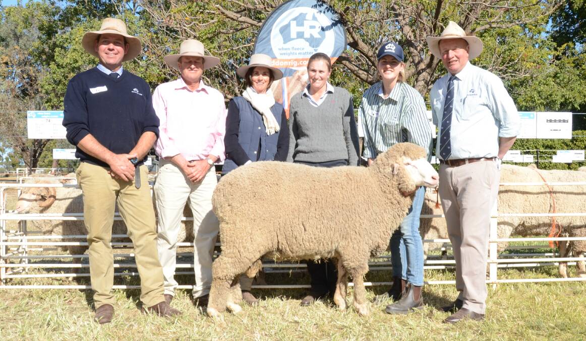 The $5500 top-priced Poll Merino ram with Haddon Rig manager, Andy Maclean; buyers Reg, Robyn and Rowena Sweeney, "Pinehurst", Merrygoen, with Olivier Falkiner holding the ram and stud principal George Falkiner.