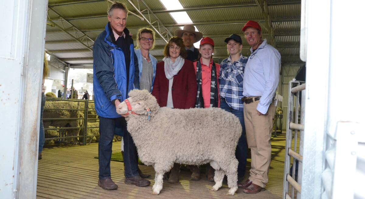 Adrian Betts holds his $5800 purchase with Pip Smith, Glenwood stud, Elizabeth Betts, Danny Tink, Peter Milling auctioneer, Daisy, Maggie and Norm Smith of Glenwood.