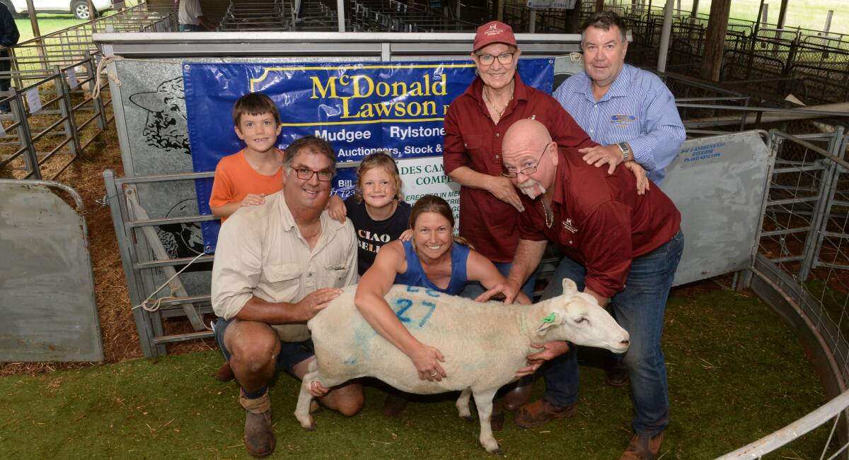 The $1250 record-priced stud ewe with buyers Samuel, Jeff, Evelyn and Ellie Rinaldo, Colla Collina stud, Clergate, with breeders Julie Huie and Jeff Lucas, Westmoreland stud, Wisemans Creek, and selling agent Peter Mitchell, McDonald Lawson, Mudgee.