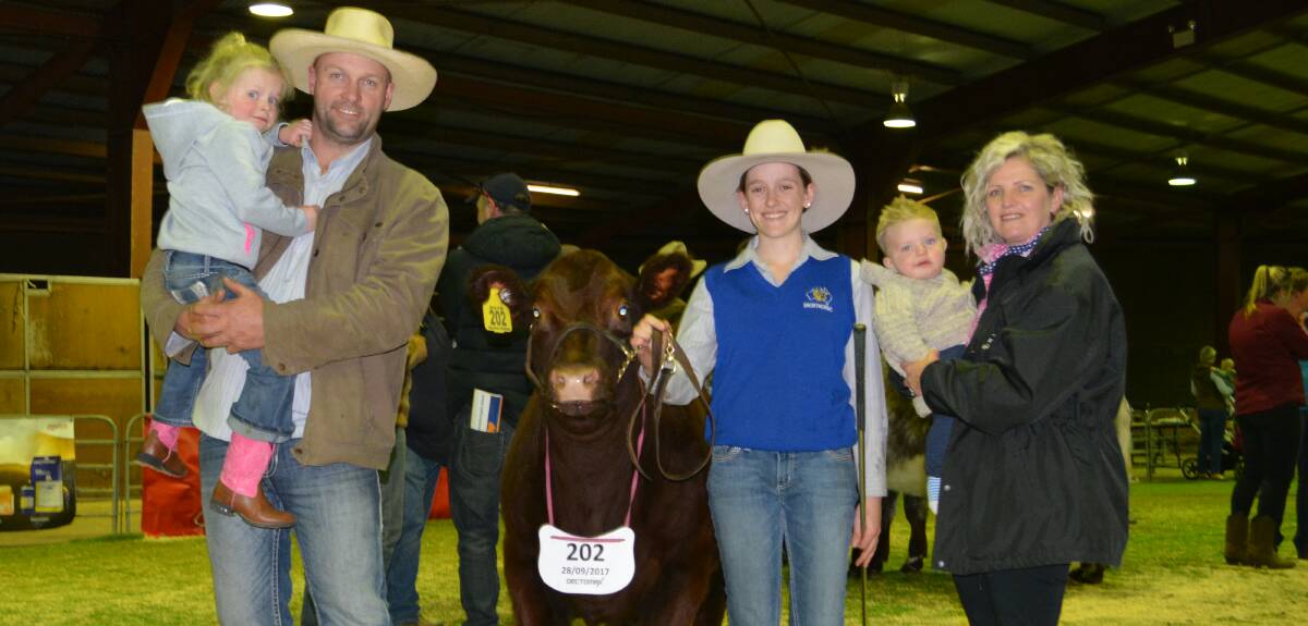 Trent and Kimberly Johnstone, Lyndhurst, with Havana, 4, and Arley, 10 months, and their $8000 sale topping female Trojon Phyllis N52 held by Miranda Eyb, Orange.
