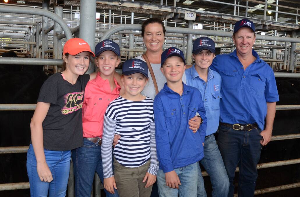 The Timbs family of “Uki”, Walcha, was buying steers and heifers for their Ebor property to fatten and trade. Pictured are Olivia Callanan, Mia, Sophie, Simone and Samuel Timbs, with Jack Callanan and Damien Timbs.