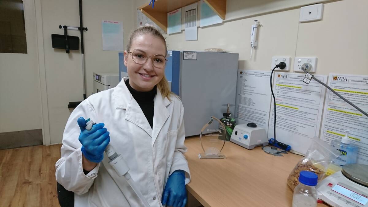 WINNER: Laboratory technician at Riverland Almonds, Hayley Pfeifer, with her trophy for winning the Leaders of the Future award, which includes a food safety learning scholarship for food courses with SAI Global to the value of $10,000.