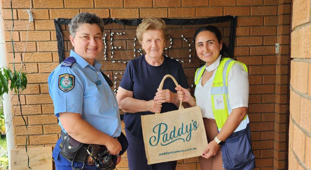Auburn Police senior constable Gabriella Di Marino with hamper recipient Anna Mijatovic and Sydney Market's Isabella Carabetta. Picture supplied