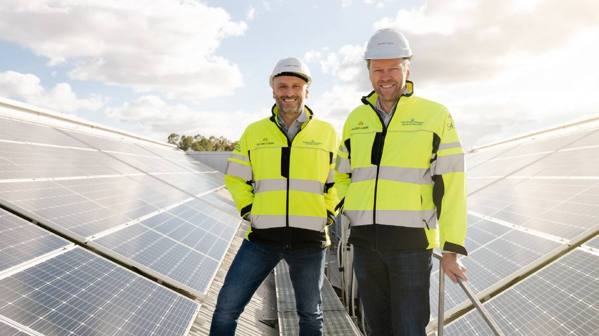 Robert Taddeo and Brett McKinnon, from winemaker Pernod Ricard, alongside the solar panels installed at Rowland Flat in the Barossa. The company is aiming to source all electricity from renewables by 2025.