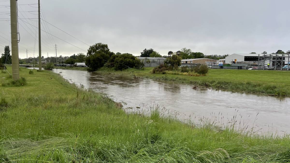 RAIN EVENT: A huge amount of water flows east along the city's storm water channel after Orange recorded its wettest day of 2021. Photo: NICK McGRATH
