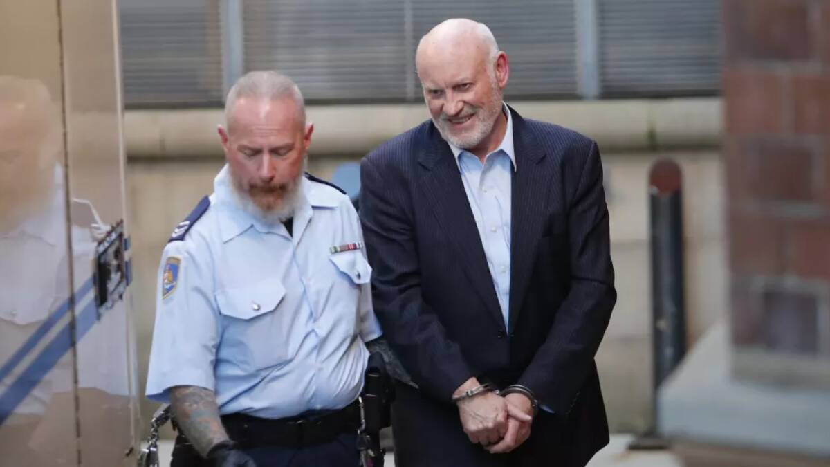 Former minister Ian Macdonald is taken into custody following a court hearing in May 2017. Photo: Daniel Munoz