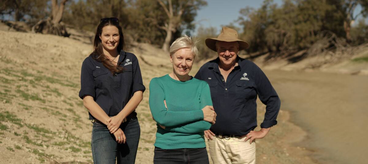 Greens MP Cate Faehrmann (centre) with Kate and Rob McBride on the Darling River near Tolarno Station. Ms Faehrmann believes the gazetting of floodplain harvesting regulations so close to an election shows "utter contempt". Picture supplied.