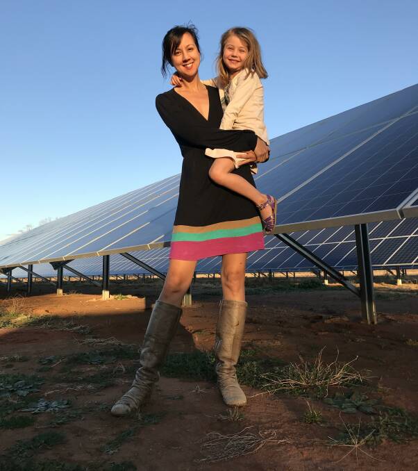 PASSIONATE: Karin Stark with her daughter Noa in front of some of the solar panels which for the 500kW solar diesel hybrid pumping system on Waverleigh.
