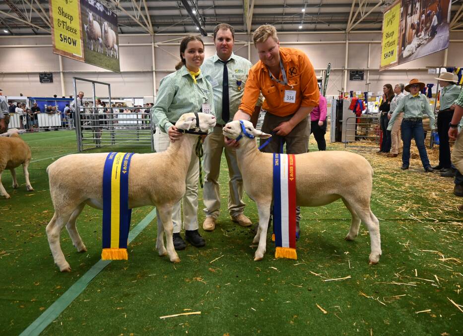 Macarthur White Suffolk's Mikayla Muscat with the reserve champion ewe, judge Brad Honeysett, Gulgong, Kinellar White Suffolk's Lachlan Patterson with the grand champion ewe. Picture by Denis Howard 