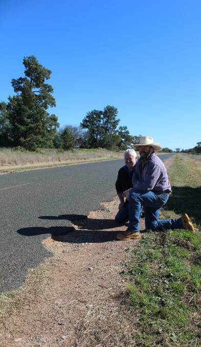 Murray Henderson, Wilga Park, Tullibigeal, and Peter Skipworth, Currebah, Lake Cargelligo, inspect part of the Wyalong Road which suffers under the weight of heavy trucks, especially during harvest. Photo: Denis Howard 