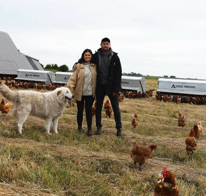 CLUCKING ALONG: Kimberley Burridge and Xavier Prime with some of their award-winning pasture-raised chickens at Cororooke, Victoria.