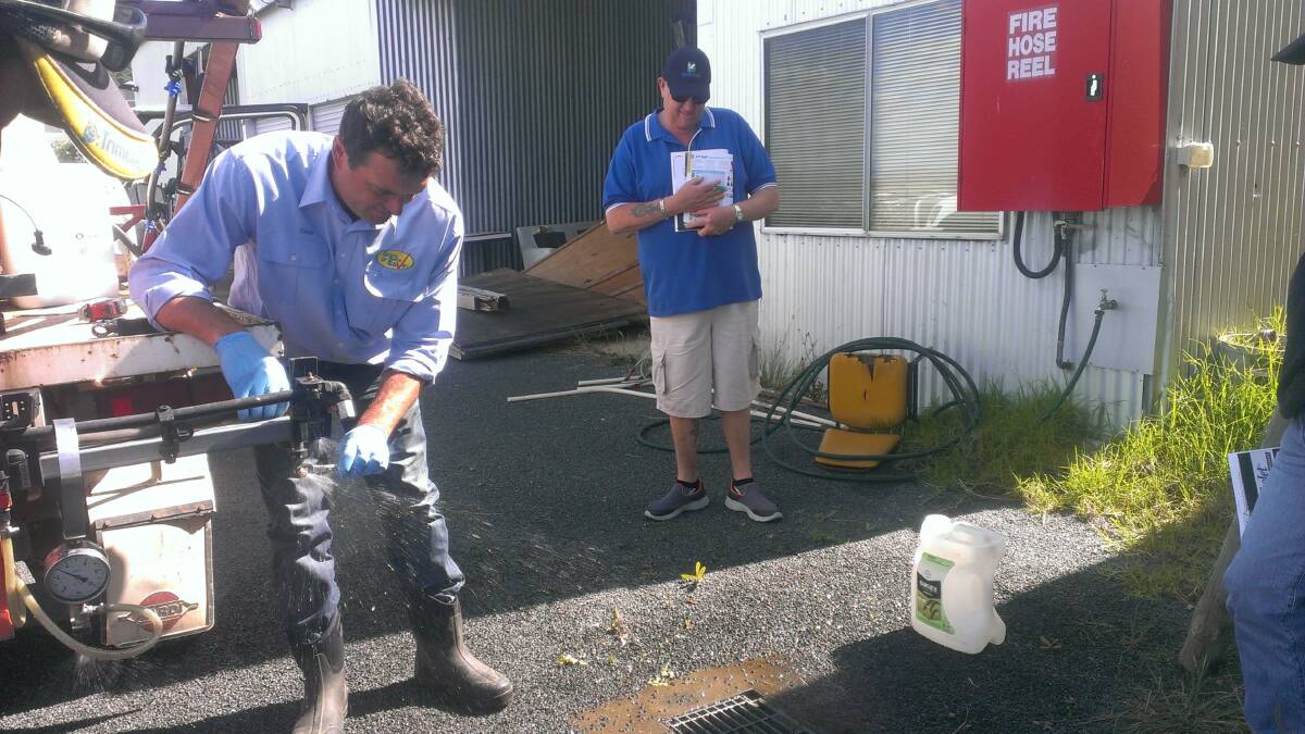 DO IT RIGHT: Spray Safe and Save accredited trainer Craig Day demonstrates nozzle output with Darren Hawkins looking on.