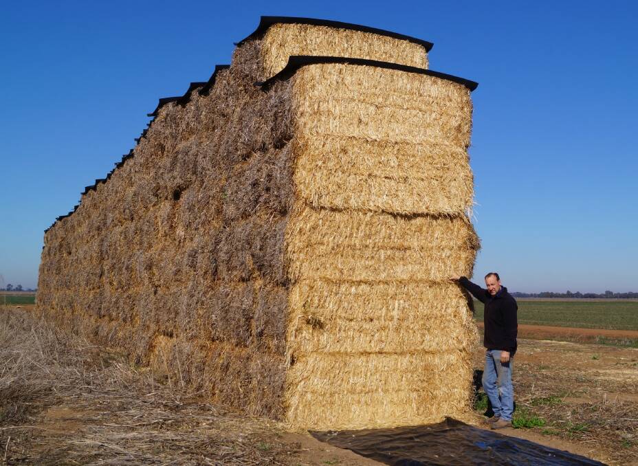 SECURE: Phil Snowden, Tocumwal, with a 'Hay Cap' -ped stack of oaten hay baled in 2016.