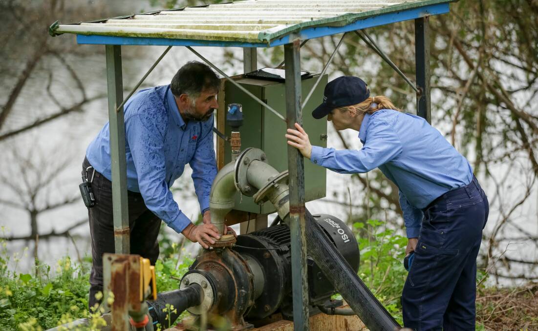 Natural Resource Access Regulator staff inspecting a pump for compliance. Picture supplied by NRAR.